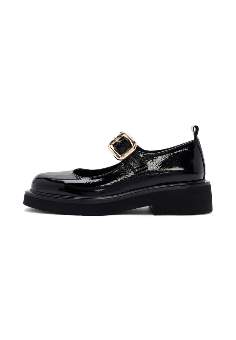 Zapato Mary Jane de charol negro con punta redonda, suela negra gruesa, detalle de hebilla lateral y un tacón pequeño. Acabado liso y brillante.
