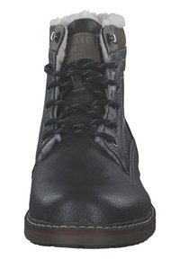 Black leather ankle boots with faux fur lining, featuring a lace-up front, metal eyelets, and contrasting brown accents at the collar.