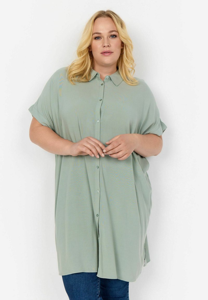 Light green, short-sleeve shirt with a button-down front, soft texture, and a loose fit, featuring a collar and side slits.