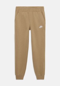 Pantalons de survêtement Nike beige en tissu doux, dotés d'une taille élastique, de deux poches latérales et d'un logo blanc sur la cuisse gauche.
