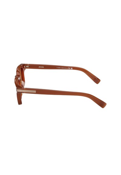 Brown, plastic eyeglasses with a distinctive wave design on the frame and sleek silver hardware accents. Slim, tapered arms.