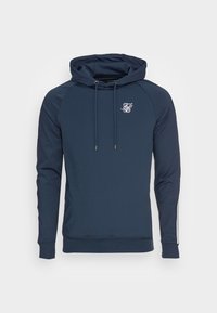 Navy blue hoodie with drawstrings, long sleeves, small white logo on left chest, and white stripe detail on the right sleeve cuff.