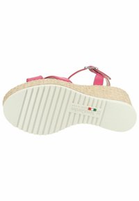 Sandal in materiale sintetico rosa con suola a cuneo avvolta in juta intrecciata. Fondo in gomma bianca testurizzata con scanalature verticali e dettaglio del logo.