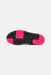 Shoe outsole featuring black rubber with pink hexagonal accents, textured for traction, and a smooth curved shape.