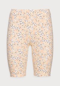 Persikka sävyiset polvipituiset legginsit, joissa on kaikkialla pieni kukkakuosi valkoisena, persikkana ja mustana vaalealla taustalla.