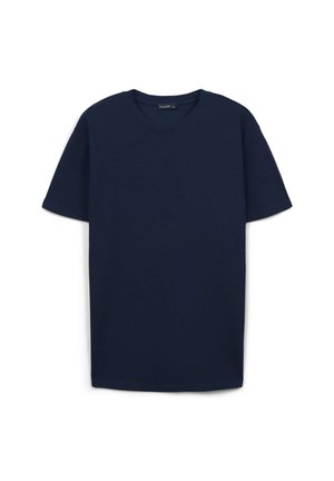 T-shirt en coton bleu marine à manches courtes, col rond et coupe standard. Sans motifs ni embellissements. Texture lisse.