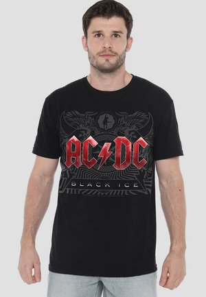 Black cotton T-shirt featuring a bold red AC/DC logo with lightning bolt, surrounded by graphic designs and the text "Black Ice." Short sleeves.