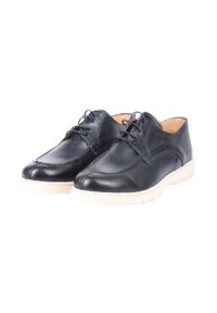 Scarpe di pelle blu scuro con punta arrotondata, dettagli cuciti e suola di colore crema a contrasto; progettate con una chiusura minimale a lacci.