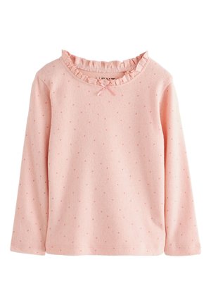 Chemise rose clair à manches longues avec un col à volants, une texture à pois et un petit nœud au centre. Tissu doux pour plus de confort.