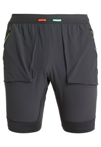 Svarta träningsshorts med dragkedje-fickor på sidorna, med gröna detaljer och ett svart midjeband med små röda och gröna öglor.