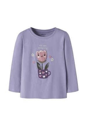 Chemise enfant à manches longues lilas avec une fleur rose souriante dans une tasse violette et le texte "You are beautiful" au-dessus.