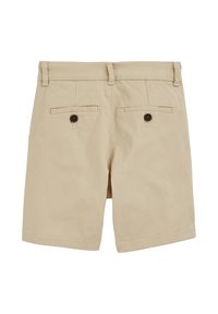 Ljusbruna shorts i bomull, med flat front, två bakfickor med bruna knappar och rak passform. Slät textur och rena kanter.