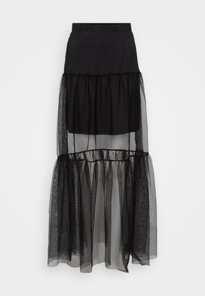 Must tükite kinnisvööga must kihtse seeliku alumine osa on poolläbipaistev ja tekstuuriga, voolav disain. Koostatud kergest materjalist.