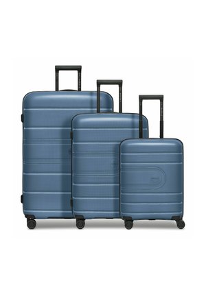 Three blue hard-shell suitcases of varying sizes with extended black telescopic handles and four wheels each, arranged side by side.