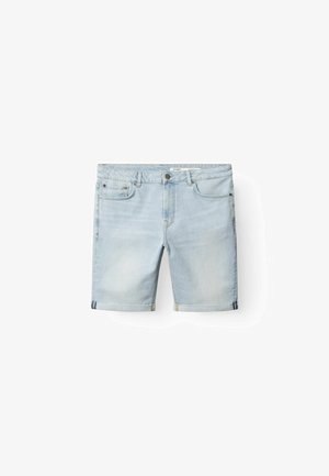 Hele sinine teksapüksid sirge lõike, üleskeeratud äärte, viie tasku ja vöökohal nööpidega sulgemisega. Sile tekstuur.