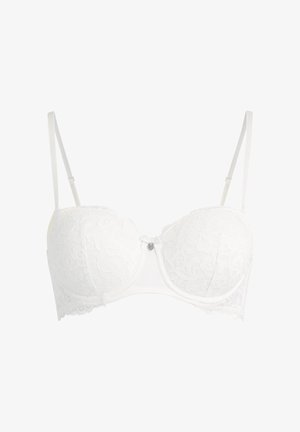White lace underwire bra with adjustable straps, padded cups, and a small decorative bow with a charm at the center front.
