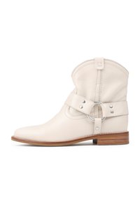 Botín de cuero blanco hasta el tobillo con punta redondeada, un cinturón con hebilla lateral y herrajes plateados. Presenta un empeine cosido y un tacón de madera.