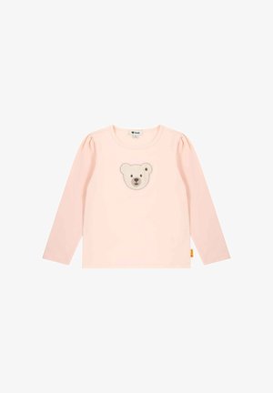Pink long-sleeve shirt made of soft fabric, featuring a bear face appliqué in the center and puffed sleeves. Tag at the hem.
