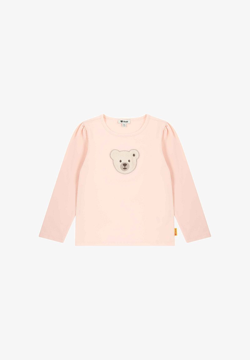 Camisa de manga larga rosa hecha de tela suave, con un aplique de cara de oso en el centro y mangas abullonadas. Etiqueta en el dobladillo.