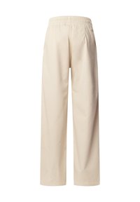 Pantalones de pierna ancha beige hechos de algodón con una cinturilla elástica. Presentan una textura suave y un diseño simple y sin adornos.