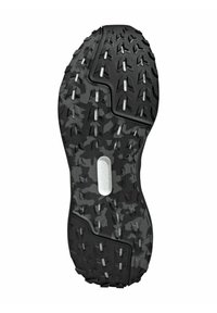 Semelle en caoutchouc noir avec un motif camouflage, texturée avec des crampons multidirectionnels pour la traction, et un insert blanc lisse au centre.
