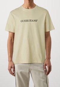 Guess Jeans Triko s potiskem - beige