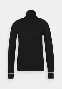 Pull en maille noir à col roulé avec manches longues, présentant une coupe ajustée et un petit logo blanc sur la poitrine. Manches accentuées avec un détail argenté.