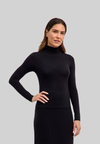 Zwarte lange mouwen turtleneck top in een aansluitend ontwerp, gemaakt van zachte, rekbare stof. Gladde textuur; naadloze randen creëren een nette uitstraling.