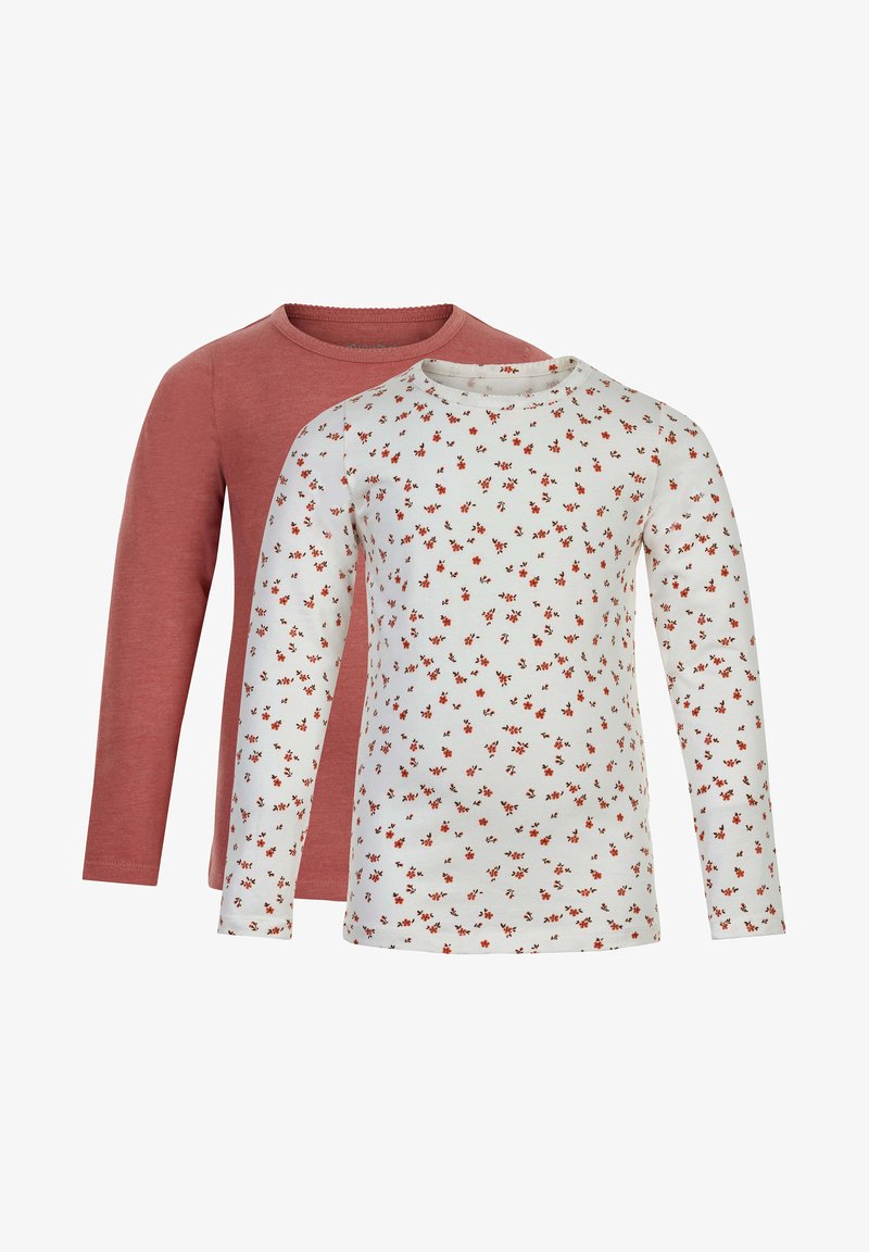 Two long-sleeve tops: one in solid dusty rose, the other in white with a red floral pattern. Both have round necklines and soft fabric.