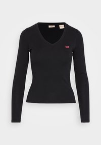 Svart långärmad V-ringad topp i mjukt material, med en liten röd Levi's-logotyp på vänster bröst och en figursydd siluett.