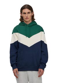 Bluza z kapturem z kolorowym blokiem w ciemnozielonym, białym i granatowym kolorze, wykonana z miękkiego materiału, z kieszenią z przodu i sznurkiem do regulacji.