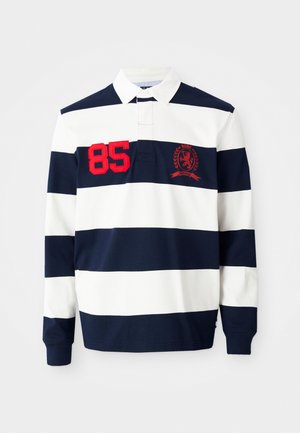 Polo à manches longues rayé bleu marine et blanc avec le numéro "85" brodé en rouge et un écusson, doté d'un col classique et d'une patte de boutonnage.