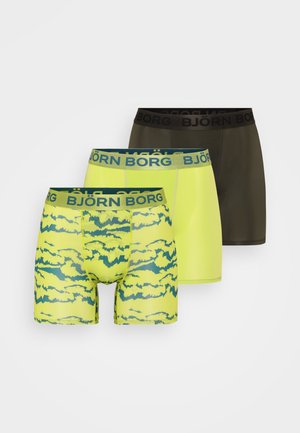 Three pairs of men’s boxer briefs: one in olive green, one in bright yellow with a blue cloud pattern, and one in solid yellow with a blue waistband.