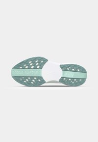 Nike schoen zool met een witte tussenzool, gestructureerde mintgroene rubberen buitenzool met uitsparingen en een centraal Nike-logo.
