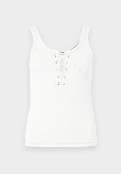 White ribbed tank top featuring a lace-up front with metal eyelets and a round neckline, finished with contrasting stitching details.