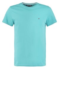 Light blue cotton t-shirt with a crew neckline and short sleeves, featuring a small logo on the left chest area. Smooth texture.