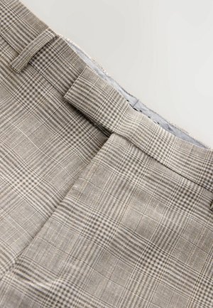 Pantalon japon en marron clair avec un motif à carreaux, tissu texturé et une taille plate avec passants de ceinture, soigneusement ajusté.