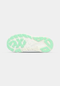 Shoe outsole in white and mint green, featuring a textured pattern for grip. Includes raised segments for traction and durability.