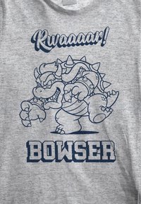 Gray t-shirt featuring a blue graphic of a character with spikes, raised claws, and the text "Rwaaaaar!" above and "BOWSER" below.