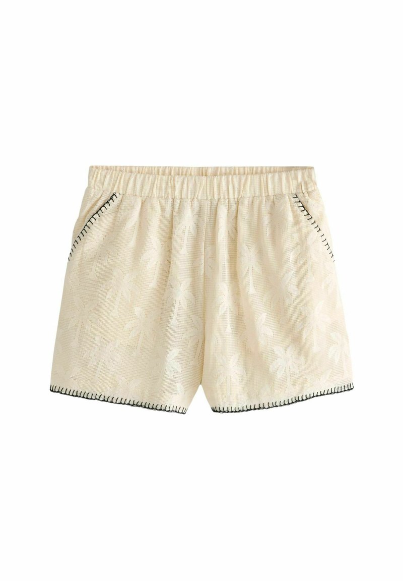 Pantaloni corti color crema con un motivo di palme, dotati di una cintura elastica, tasche laterali e cuciture nere a contrasto lungo l'orlo.