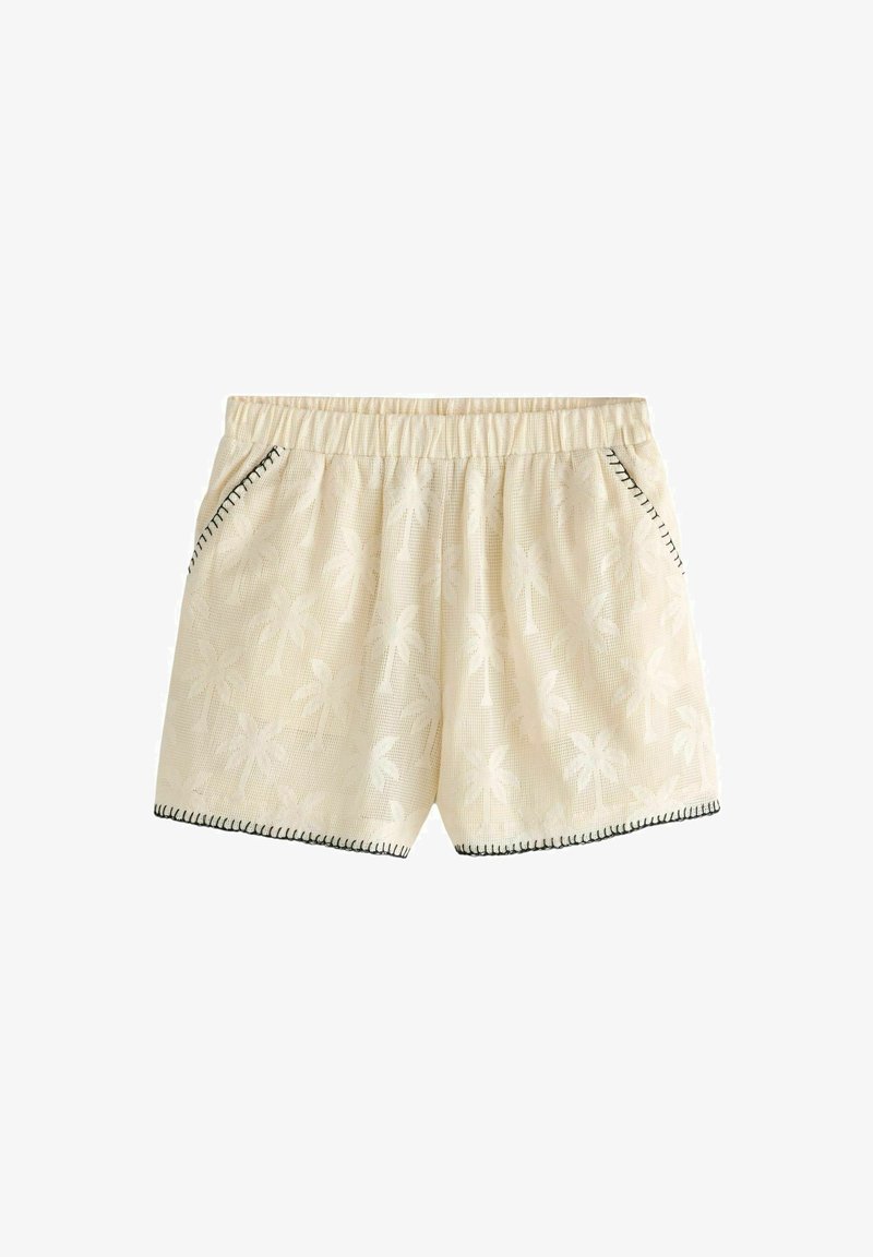 Shorts crème avec un motif de palmier, taille élastique, poches latérales et coutures noires contrastantes le long de l'ourlet.