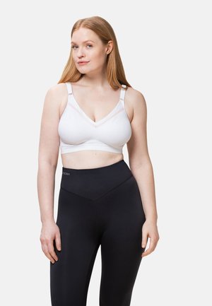 Soutien-gorge sans fil blanc avec un motif texturé et un décolleté en V, complété par des bretelles ajustables ; associé à des leggings noirs taille haute.