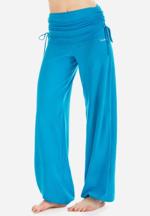 Turquoise wide-leg pants with a ruched waistband, drawstring ties, and soft fabric, designed for comfort and ease of movement.