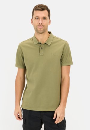 Olive green polo shirt with a collar, short sleeves, and subtle logo detail. Made of smooth, lightweight fabric; features button closure.
