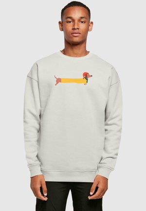 Light gray sweatshirt featuring a cartoon dachshund design in yellow, brown, and red. Long sleeves and ribbed cuffs complete the look.