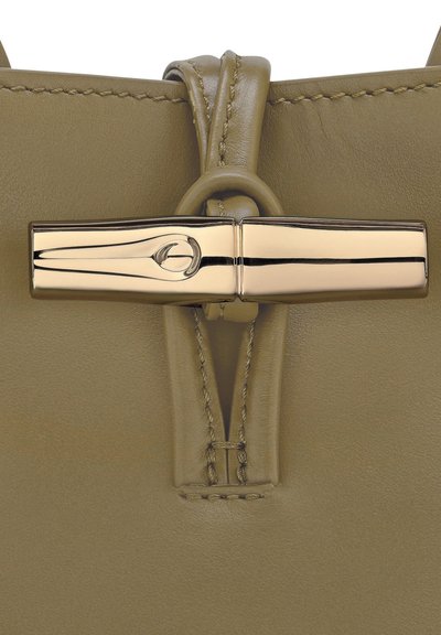 Olive green leather handbag with gold-tone hardware, featuring a sleek closure mechanism and visible stitching detail.