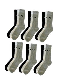 Sechs Paar Socken in Schwarz- und Grautönen mit geripptem Design und kontrastierenden weißen Bündchen; das Logo ist auf jeder Socke sichtbar.