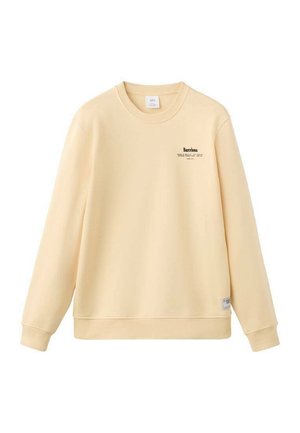 Bluza galbenă din bumbac cu mâneci lungi, guler rotund  și un mic imprimeu text negru cu cuvântul "Barcelona" pe piept. Croială clasică.