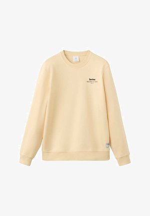 Žltá bavlnená mikina s dlhými rukávmi, okrúhlym výstrihom a malým čiernym nápisom "Barcelona" na hrudi. Klasický strih.