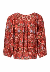 Blouse à motifs rouges avec un col rond, des manches larges et un ourlet élastiqué. Le design comprend des formes abstraites multicolores et des textures.